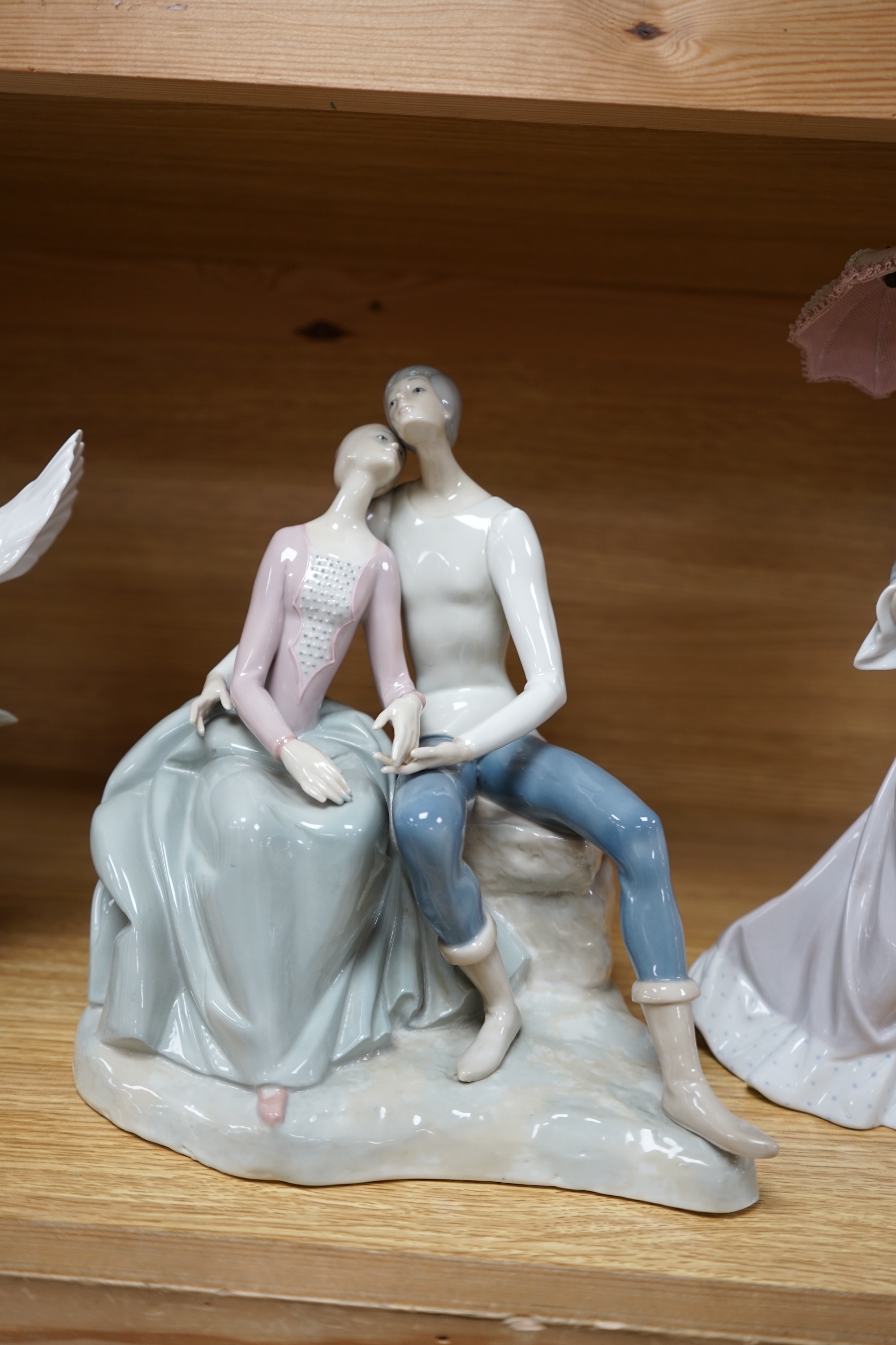 Three Lladro figure groups to include a dancer and a seagull together with another Spanish porcelain group, largest 31cm high. Condition - good